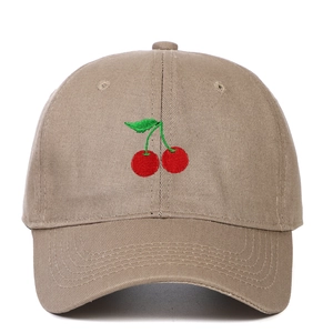 Close-up of the detailed red cherry embroidery on the khaki cotton twill baseball cap