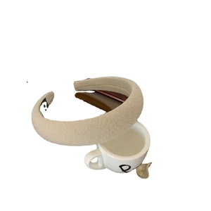 Beige padded plaid headband with textured fabric in a retro preppy style for women
