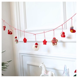 Christmas wool felt garland with Santa, snowman and gingerbread man hanging on wall