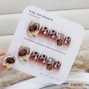 Handmade press-on nails featuring luxury leopard print and 3D metal bow with crystals