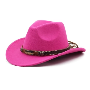 Detail of rose red cowboy hat with woven band, ethnic beads and gold feather pendant