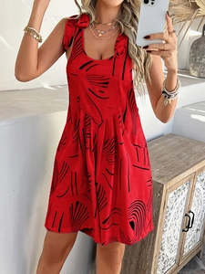 Detailed view of red bohemian halter jumpsuit featuring black abstract pattern and side pockets