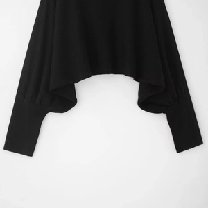 Fashionable black knit short top with bubble sleeves and long ribbed cuffs on white background