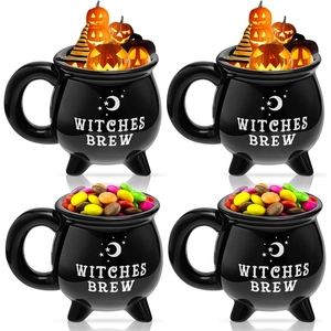 Ceramic witches brew mugs filled with Halloween treats and wizard hat decorations