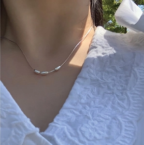 Minimalist S925 silver snake chain necklace with three smooth bean pendants on a model