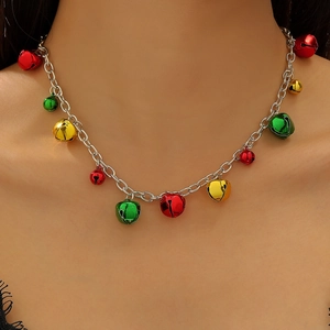 Close-up of Christmas necklace with colorful red, green and gold jingle bells on silver chain
