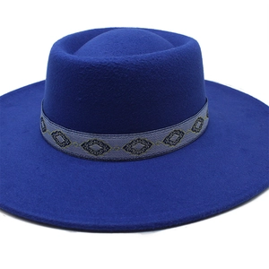 Detail view of royal blue wide brim wool fedora hat with geometric jacquard woven band
