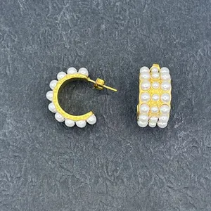 Elegant 18k gold-plated C-shaped earrings featuring three rows of white round pearls