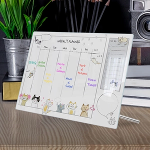 Close-up of acrylic weekly planner with cute cat illustrations and metal stand