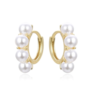 Elegant gold-plated hoop earrings with four white pearls on a reflective white background