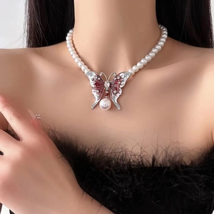 Collier avec pendentif papillon en velours rouge et perles pour un look féminin élégant