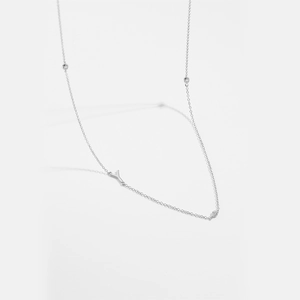 Macro shot of silver plated copper necklace featuring a letter Y pendant and clear gems