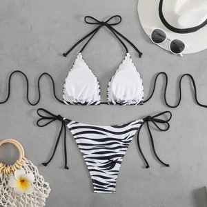 Detail of zebra print bikini with side ties, black trim and white interior lining