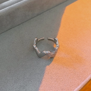 Detail view of heart zircon open ring with alternating polished and pave settings