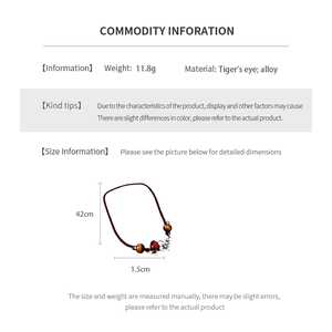 Detailed macro view of the tiger's eye beads and strawberry alloy pendant necklace