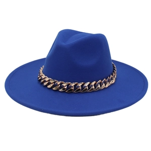 Detail of royal blue fedora hat with elegant wide brim and gold acrylic chain link trim