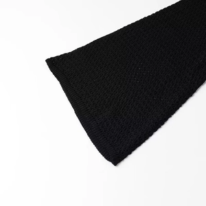 Detail shot of black crochet knit flare sleeves with intricate openwork mesh texture