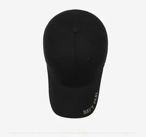 Close-up of black cotton baseball cap with gold Navy Seal embroidery on the brim