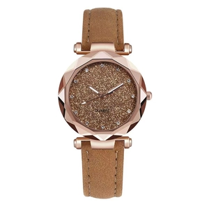 Detail of rose gold faceted bezel and brown glitter dial with rhinestone indices
