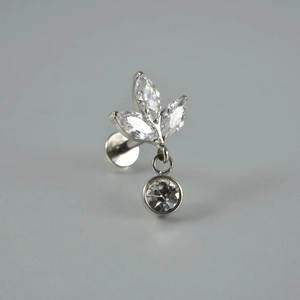 Détail macro du piercing lèvre en titane F136 avec zircon marquise et pendentif