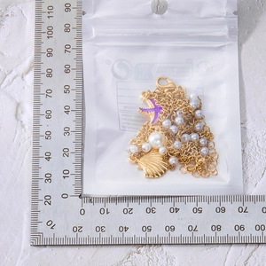 Detail of gold multilayer starfish shell bracelet with ruler for size measurement