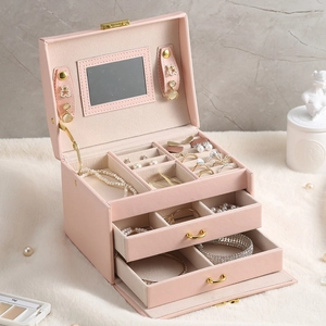 Pink multi-layer PU leather jewelry box with mirrors and drawers on white plush rug
