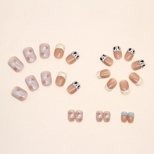 Star and cow print press-on nails with French tips and glossy milk pattern finish