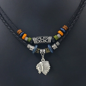 Close-up of double-layer leather necklace with tribal beads and native chief pendant