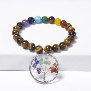 Detail of tiger eye beads and Tree of Life charm on a chakra stone stretch bracelet
