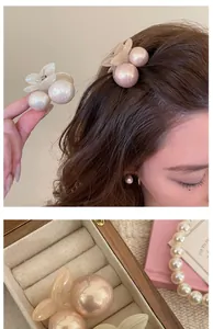 Detailed close-up of cherry hair clips featuring resin pearls and translucent petals
