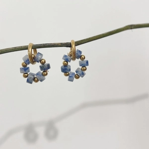 18K gold plated stainless steel hoop earrings with blue natural stone beads on a green branch