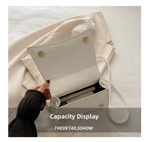Internal view of a white quilted crossbody bag showing capacity for phone and accessories