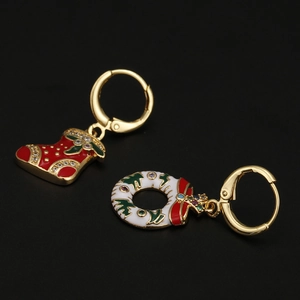 Detail of Christmas earrings featuring red stocking and white wreath with enamel finish