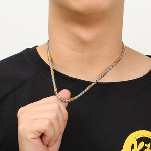 Silver and gold mixed link chain necklace for men shown on neck in close-up view