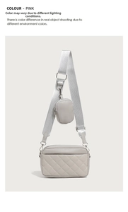 Macro shot of pink quilted crossbody camera bag with silver zipper and mini pouch