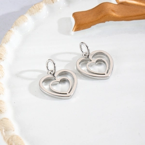 Detail of silver double-heart charms with polished finish for DIY jewelry crafting