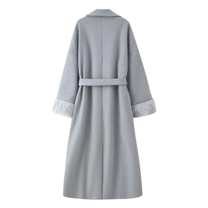 Back view of grey wool coat featuring tied waist belt and faux fur cuffs detail
