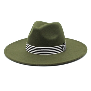 Close-up of olive green wool fedora with a striped black and white decorative band