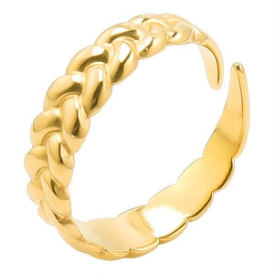 Macro detail of golden triple braided open ring with polished mirror finish texture