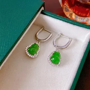 Elegant silver earrings featuring green zircon gourd drops on a velvet jewelry box