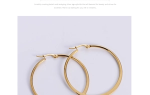 Close-up of gold titanium steel hoop earrings showing the secure clasp and polished finish