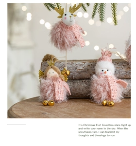 Close-up of pink plush Christmas ornaments with bells on a vintage wooden tray