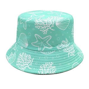 Detail shot of mint green bucket hat with white starfish and coral print pattern