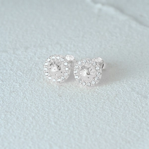 Macro shot of S925 sterling silver stud earrings with sparkling pave zircon stones
