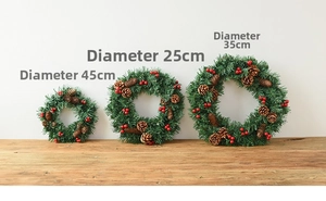 Three sizes comparison of Christmas wreath with pine needles, cones and red berries