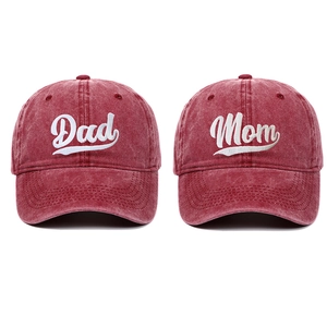 Close-up of vintage red washed cotton baseball caps with Dad and Mom embroidery