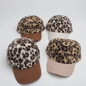 Detailed texture of leopard print faux fur and corduroy brim on winter baseball caps
