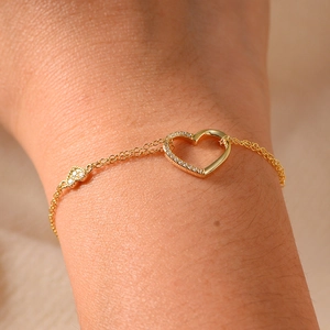 Detailed close-up of a double-layer gold heart bracelet featuring sparkling cubic zirconia