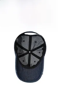 Detail of dark blue denim baseball cap interior with reinforced seams and breathable eyelets