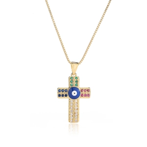 Gold evil eye cross pendant necklace with colorful cubic zirconia on a white background
